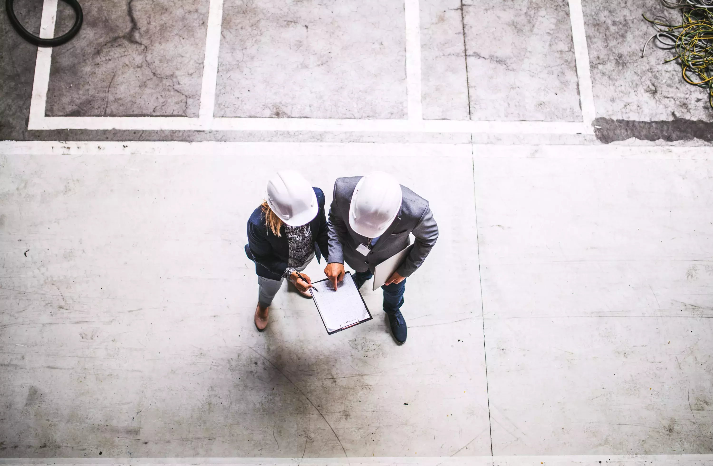 A top view of an industrial man and woman engineer with clipboard in a factory. 