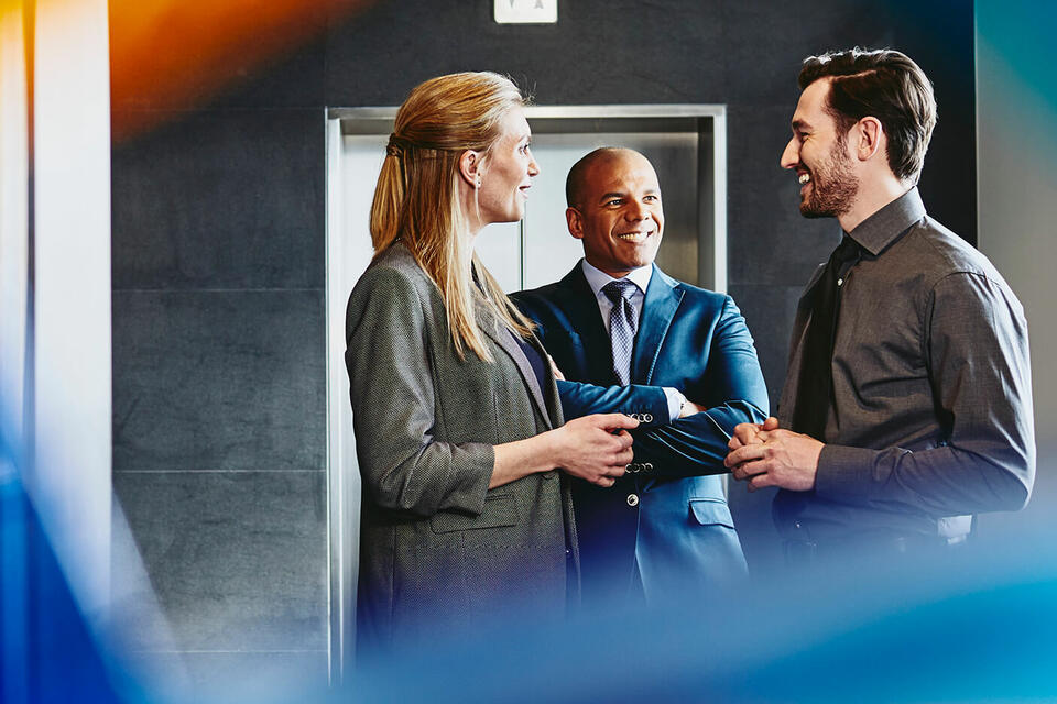 most-sought-after-employers-canada-2023-randstad-body.jpg Group of people talking near an elevator.
